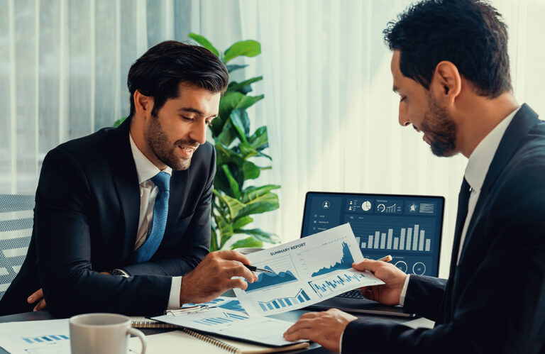 two-men-suits-discuss-financial-report 1